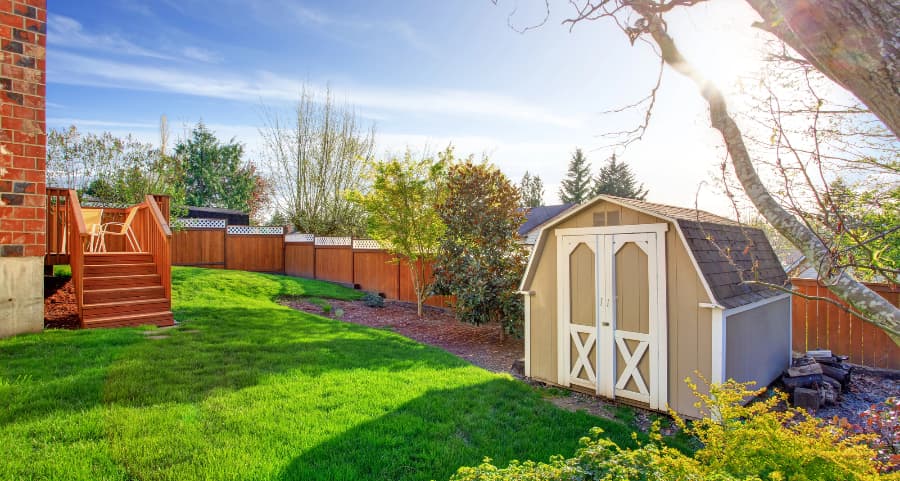 Fenced backyard with storage shed in Lansing